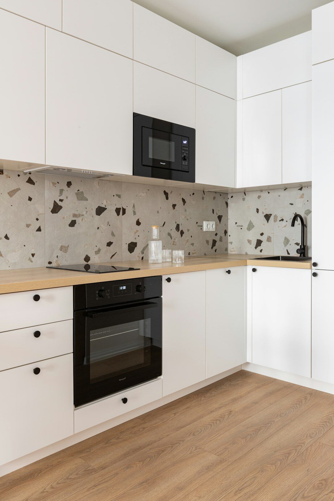 Bright modern home kitchen with wooden countertop and herbs
